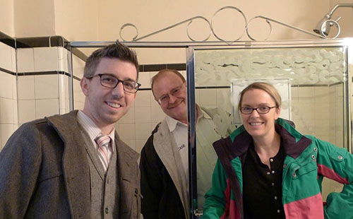 TJ Monahan, Steve Magill), and Allie Mann in bathroom before rennovation