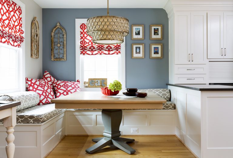 eat in area in kitchen light blue walls red accents banquette seating