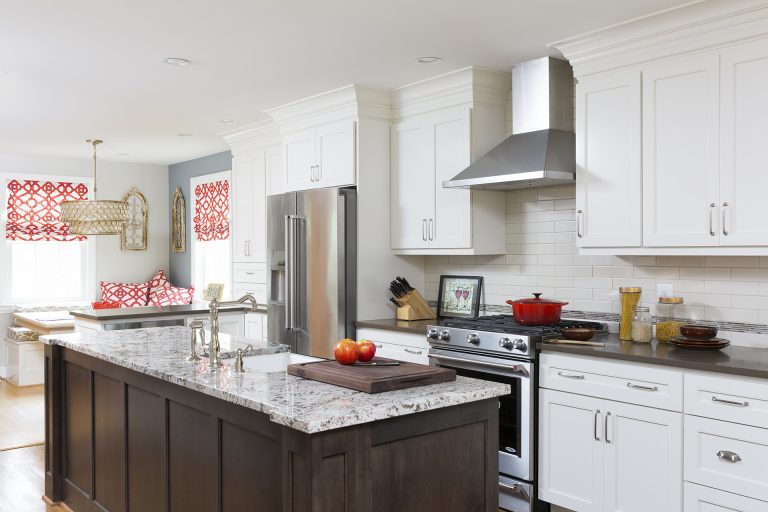 traditional kitchen white outer cabinetry dark wood island wood floors stainless steel appliances