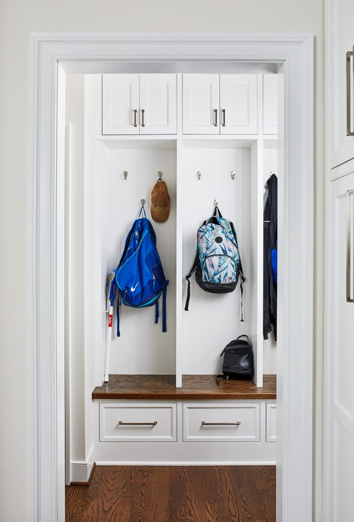 transitional open mudroom paneled walls with individual cubbies and drawers at the top and bottom